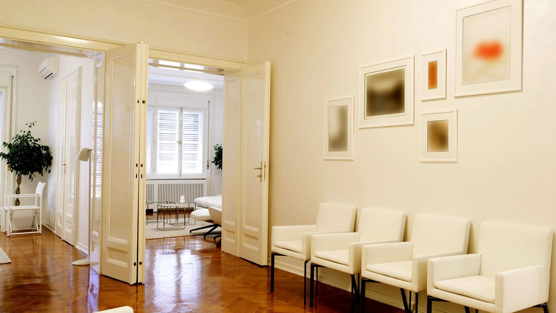 Bright waiting room featuring white chairs