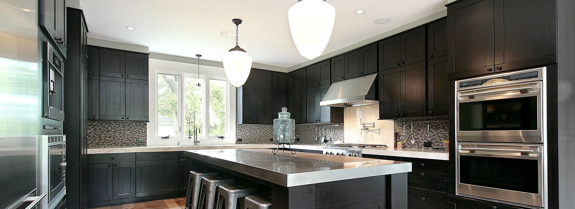 Modern kitchen featuring sleek black cabinetry